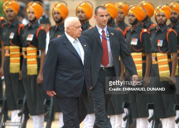 Israeli Prime Minister Ariel Sharon , accompanied by an unidentified Israeli security guard, reviews a guard of honour during a welcoming ceremony at...