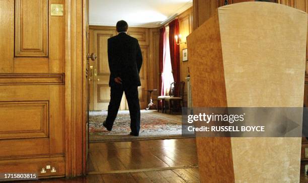 Britain's Prime Minister Tony Blair walks after his monthly televised news conference in Downing Street in London, 30 July, 2003. Blair, who is about...