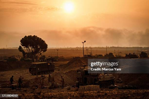 Soldiers from an artillery unit stand ready near their position a few miles outside of Gaza, near Sderot, Israel, Monday, Oct. 9, 2023. Israel was...