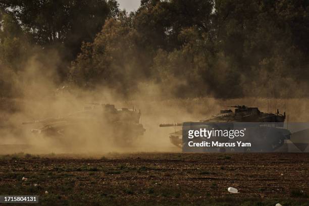 Israeli Tanks move into position as the military stage and guard its positions near Mavki'im, Israel, Monday, Oct. 9, 2023. Israel was caught by...