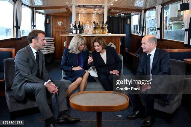 French President Emmanuel Macron and his wife Brigitte Macron and German Chancellor Olaf Scholz and his wife Britta Ernst travel in a boat during a...