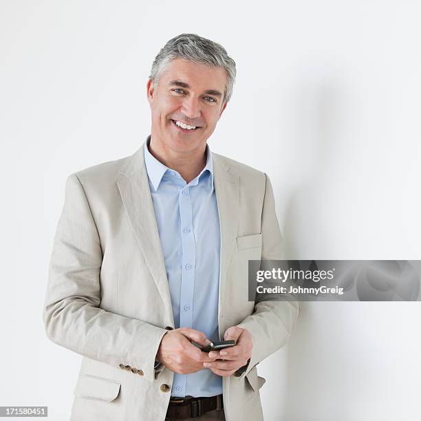 mature businessman with mobile phone - ceo white background stock pictures, royalty-free photos & images