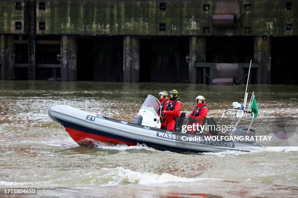 Police patrol by boat during a harbor tour of the French and German presidents in Hamburg, northern Germany, on October 9 on the first day of two-day...