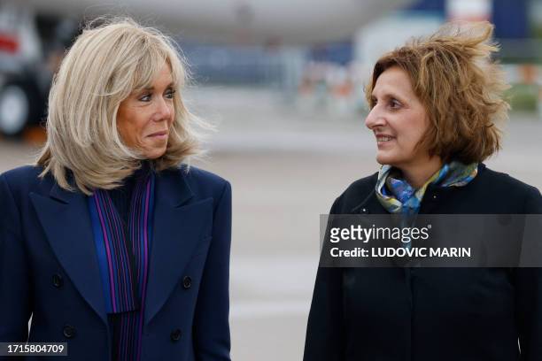 The French president's wife Brigitte Macron and the German chancellor's wife Britta Ernst stand side by side during a visit to the Airbus plant on...