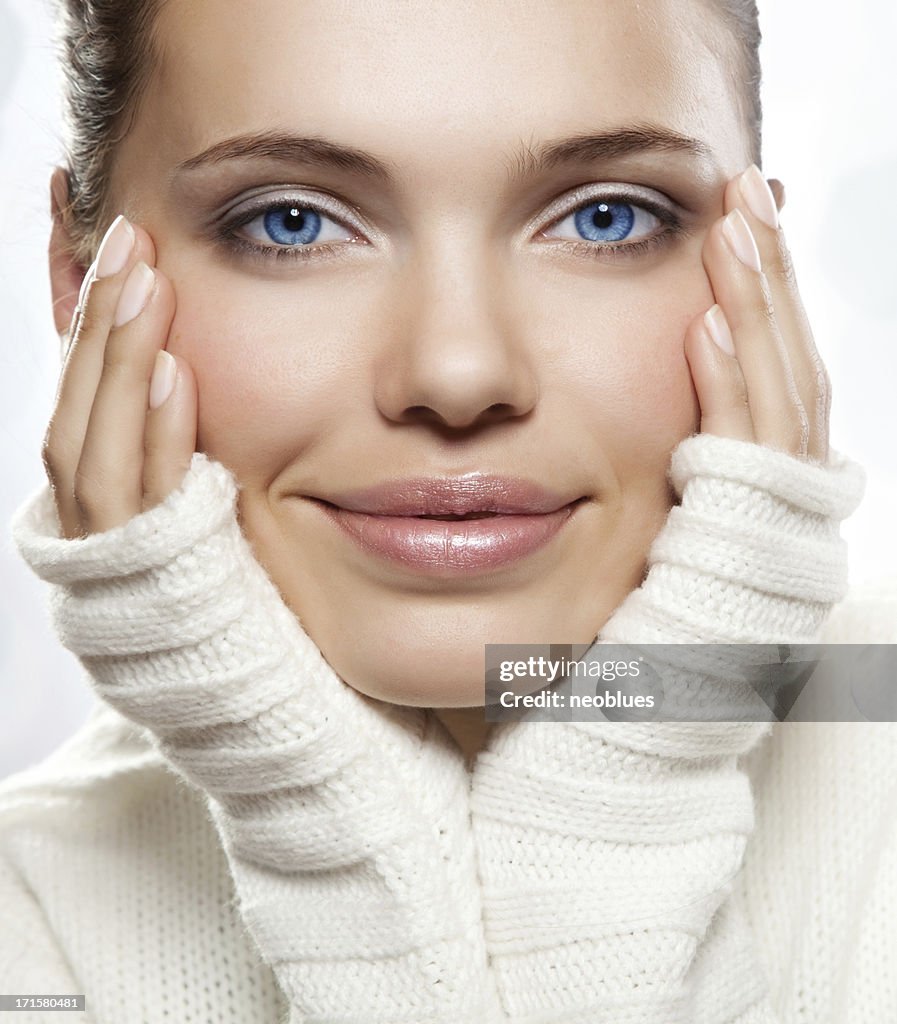 Close-up beautiful face of young woman with white sweater