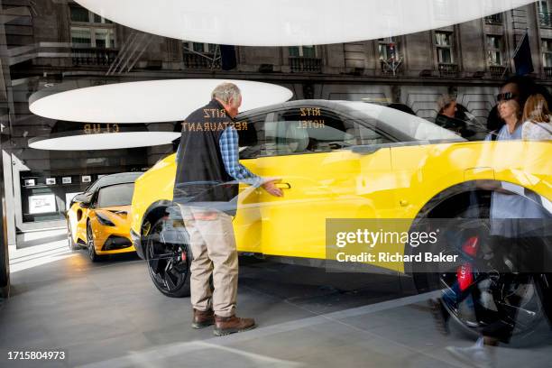 Potential buyers look at a Lotus 'Eletre' EV car which is positioned in the window of the brand's showroom on Piccadilly, on 9th October 2023, in...