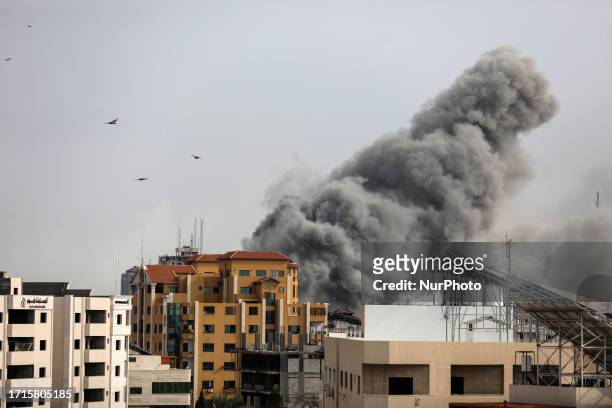 Plume of smoke rises in the sky of Gaza City during an Israeli airstrike on October 9, 2023. Israel relentlessly pounded the Gaza Strip overnight and...