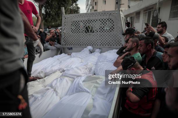 More than 15 bodies of the Shamlakh family in a vehicle in front of the mortuary building in Al-Shifa Hospital. They were killed in an Israeli raid...