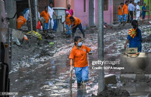 Member of the Sikkim disaster management team struggles to walk through the muddy water caused by flash floods after a lake burst. After a glacial...