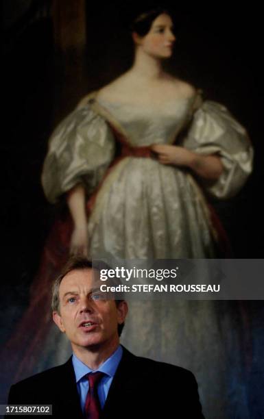 British Prime Minister Tony Blair stands in front of Augusta Ada Byron, Countess of Lovelace, by Margaret Carpenter, during a press conference at...