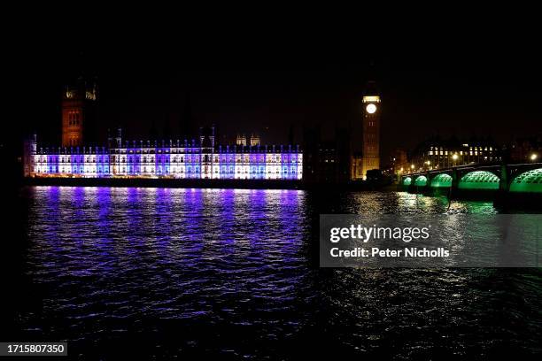 The Houses of Parliament are lit up blue and white in support of Israel on October 9, 2023 in London, England. The Palestinian militant group Hamas...