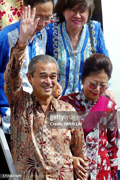 Malaysia's new Prime Minister Abdullah Ahmad Badawi waves to supporters accompanied by his wife Endon Mahmood upon arriving in the northern state of...