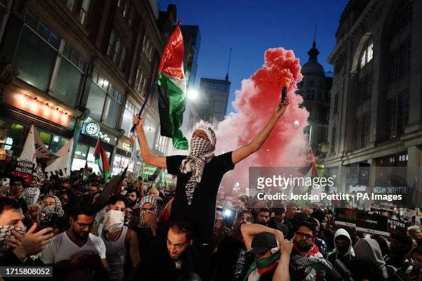People take part in a Palestine Solidarity Campaign demonstration near the Israeli Embassy, in Kensingston, London, as the death toll rises amid...