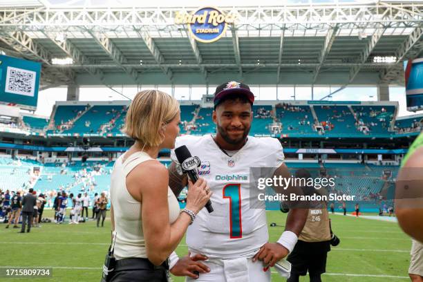 Tua Tagovailoa of the Miami Dolphins talks with Fox Sports analyst Shannon Spake after a team victory over the New York Giants at Hard Rock Stadium...