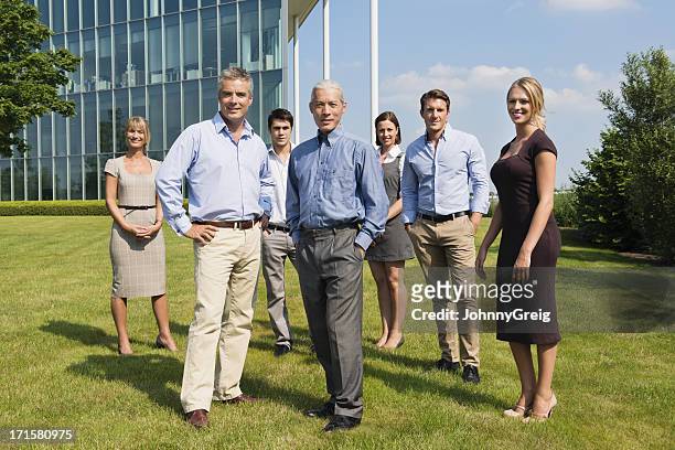 confident business people standing at lawn - organized group photo stock pictures, royalty-free photos & images