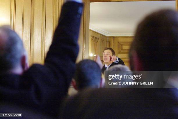 British Prime Minister Tony Blair calls on a reporter during his monthly press conference in Downing Street, London, 26 February, 2004. The...