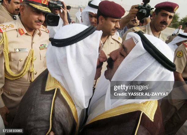 Sheikh Nasser Sabah al-Ahmad al-Sabah , son of Kuwait's Prime Minister and adviser Sheik Sabah, kisses his father upon his arrival at Kuwait...