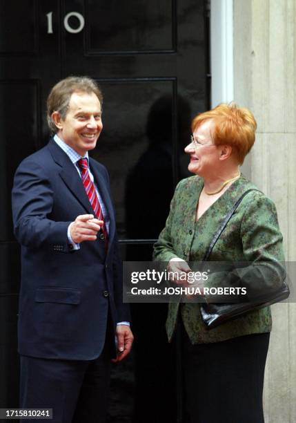 British Prime Minister Tony Blair laughs with Finnish President Tarja Halonen as she leaves No. 10 Downing Street 11 May, 2004. AFP PHOTO/JOSHUA...