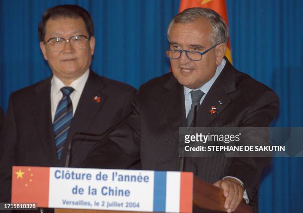 French Prime Minister Jean-Pierre Raffarin , flanked by Li Changchun of the Chinese Communist Party Polit Bureau Permanent Committee , speaks at the...