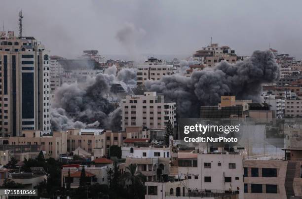 Smoke rises over a buildings in Gaza City on October 9, 2023 during an Israeli air strike.