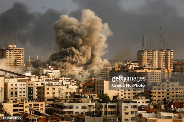 Smoke rises over a buildings in Gaza City on October 9, 2023 during an Israeli air strike.