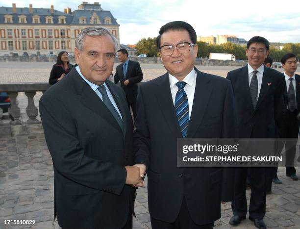 French Prime Minister Jean-Pierre Raffarin welcomes Li Changchun of the Chinese Communist Party Polit Bureau Permanent Committee at the Chateau of...