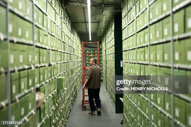 Fungarium Collections manager Lee Davies walks down an aisle of boxes containing fungi samples stored within the Fungarium at the Royal Botanic...