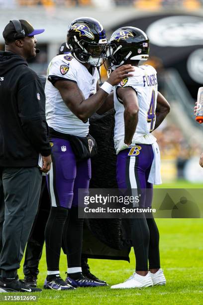 Baltimore Ravens quarterback Lamar Jackson talks to Baltimore Ravens wide receiver Zay Flowers during the regular season NFL football game between...