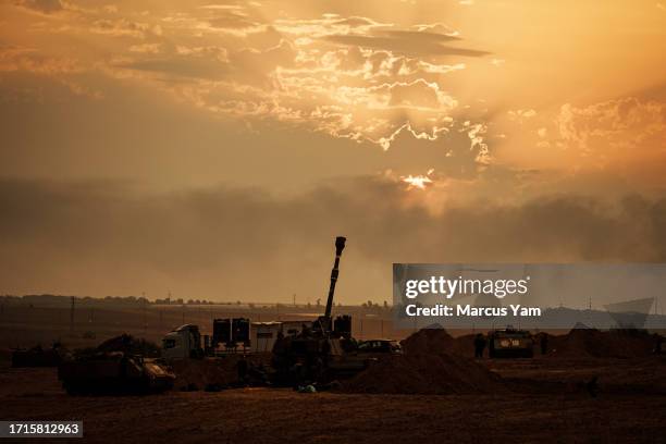 Soldiers from an artillery unit stand ready near their position a few miles outside of Gaza, near Sderot, Israel, Monday, Oct. 9, 2023. Israel was...