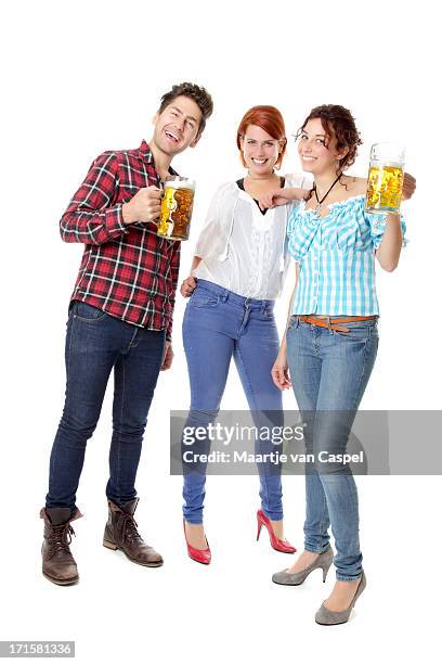 young beer fest visitors partying with beer steins - young men drinking beer stock pictures, royalty-free photos & images