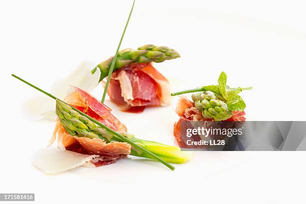 a prosciutto appetizer with dry cured ham - canape stock pictures, royalty-free photos & images