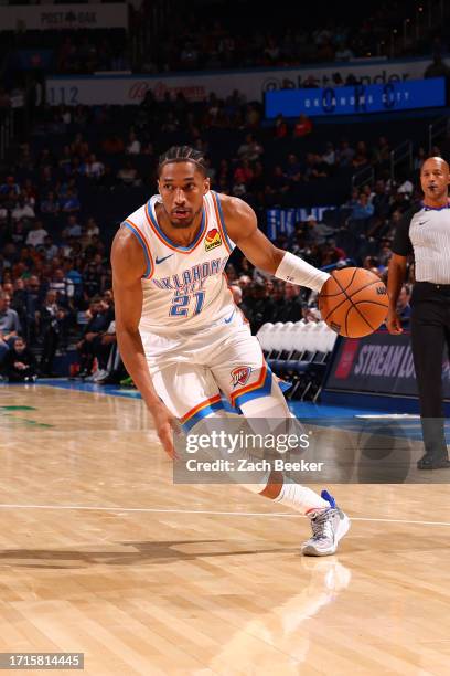 Aaron Wiggins of the Oklahoma City Thunder dribbles the ball during the game against the San Antonio Spurs on October 9, 2023 at Paycom Arena in...