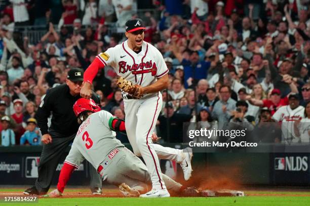 Matt Olson of the Atlanta Braves reacts after tagging out Bryce Harper of the Philadelphia Phillies at first base for the win in Game 2 of the...