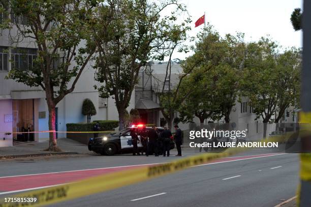 Police officers are seen outside the visa office of the Chinese consulate, where earlier a vehicle crashed into the building, in San Francisco,...