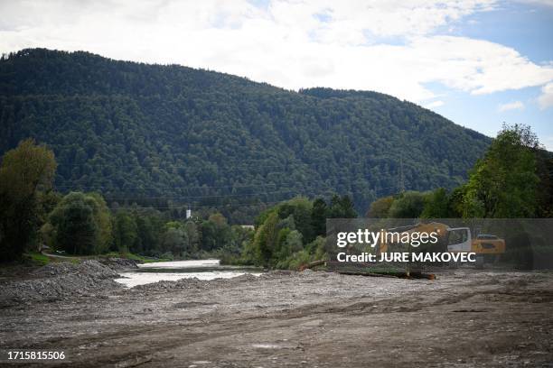 An excavator is seen working on the bank of the Savinja River, in Recica ob Paki, Slovenia on September 19 after heavy floods hit Slovenia in the...