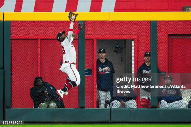 Michael Harris II of the Atlanta Braves leaps at the wall and robs a hit from Nick Castellanos of the Philadelphia Phillies during the ninth inning...