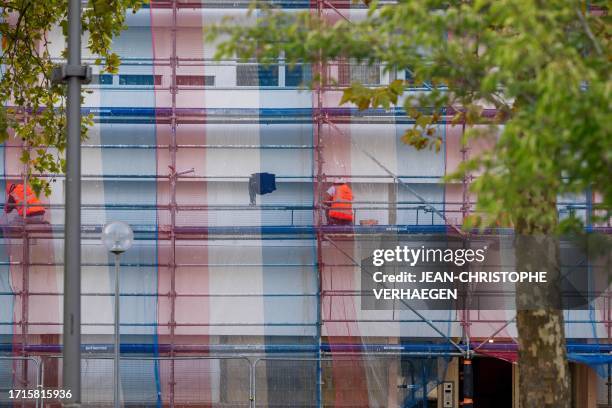 Workers work on the renovation of a public low-cost housing building in Metz-Borny district in Metz, eastern France, on October 9, 2023. Metz-Borny...