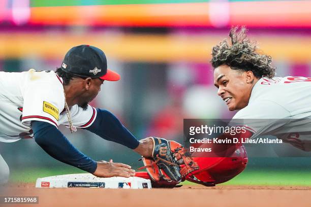 Cristian Pache of the Philadelphia Phillies slides safely past Ozzie Albies of the Atlanta Braves for a stolen base during the fifth inning in Game...