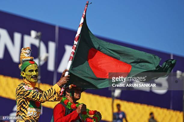 Fan waves Bangladesh's national flag before the start of the 2023 ICC Men's Cricket World Cup one-day international match between England and...