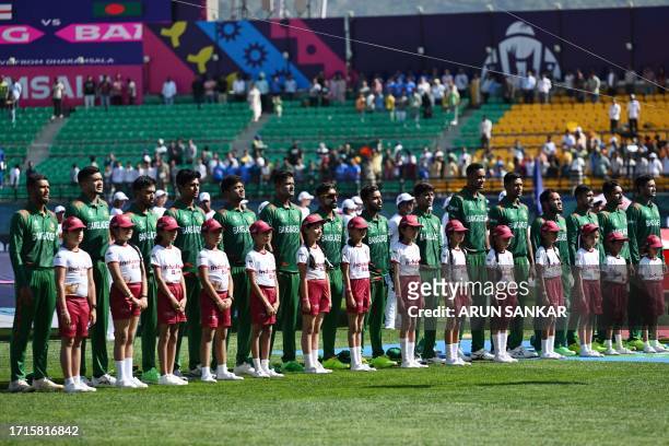 Bangladesh's cricketers listen the national anthem before the start of the 2023 ICC Men's Cricket World Cup one-day international match between...