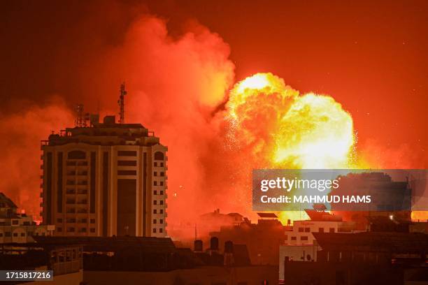 Fireball erupts from an Israeli airstrike in Gaza City on October 9, 2023. The death toll from the unprecedented assault by Palestinian militant...