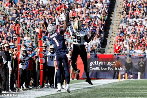 New Orleans Saints cornerback Paulson Adebo breaks up a pass for New England Patriots wide receiver DeVante Parker during a game between the New...
