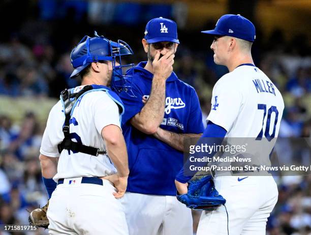Los Angeles, CA Pitching coach Mark Prior, center along with catcher Will Smith talks with starting pitcher Bobby Miller of the Los Angeles Dodgers...