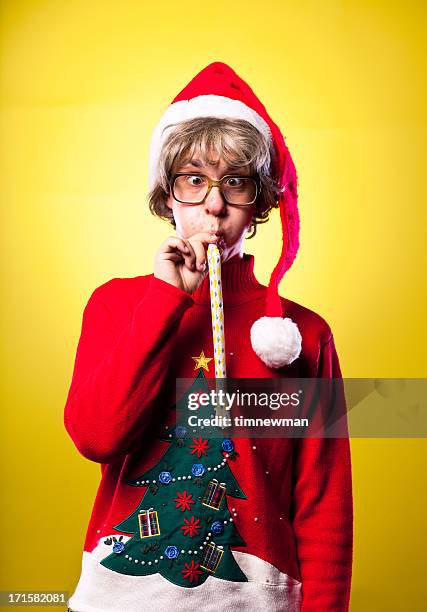ugly sweater christmas nerd boy portrait blowing party whistle - stereotypical stock pictures, royalty-free photos & images