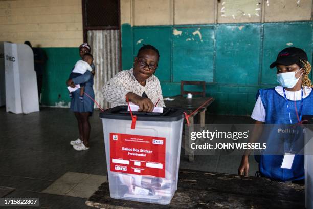 Voter casts her ballot at a voting station in Monrovia on October 10, 2023. Liberians began voting Tuesday on whether to give football legend George...