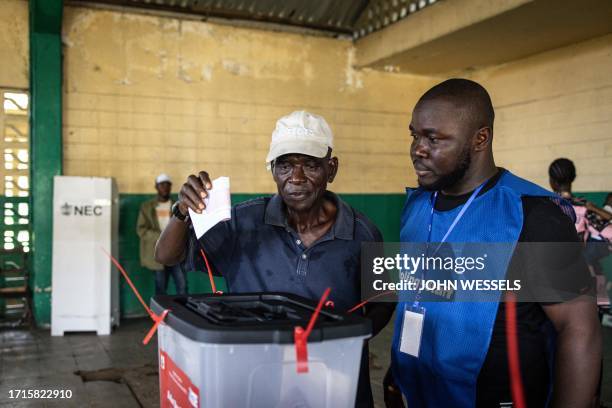 Voter casts his ballot at a voting station in Monrovia on October 10, 2023. Liberians began voting Tuesday on whether to give football legend George...