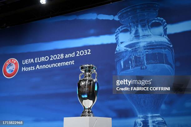 Picture taken on October 10 shows the UEFA Euro trophy on display a few moments before the announcement of the elected countries which will host the...