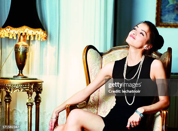 fashion model enjoys the riches - antique sofa styles stock pictures, royalty-free photos & images