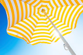 Beach umbrella against blue morning sky