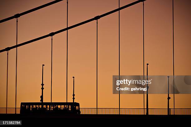 bus on the road and bridge at sunrise - bus hungary stock pictures, royalty-free photos & images